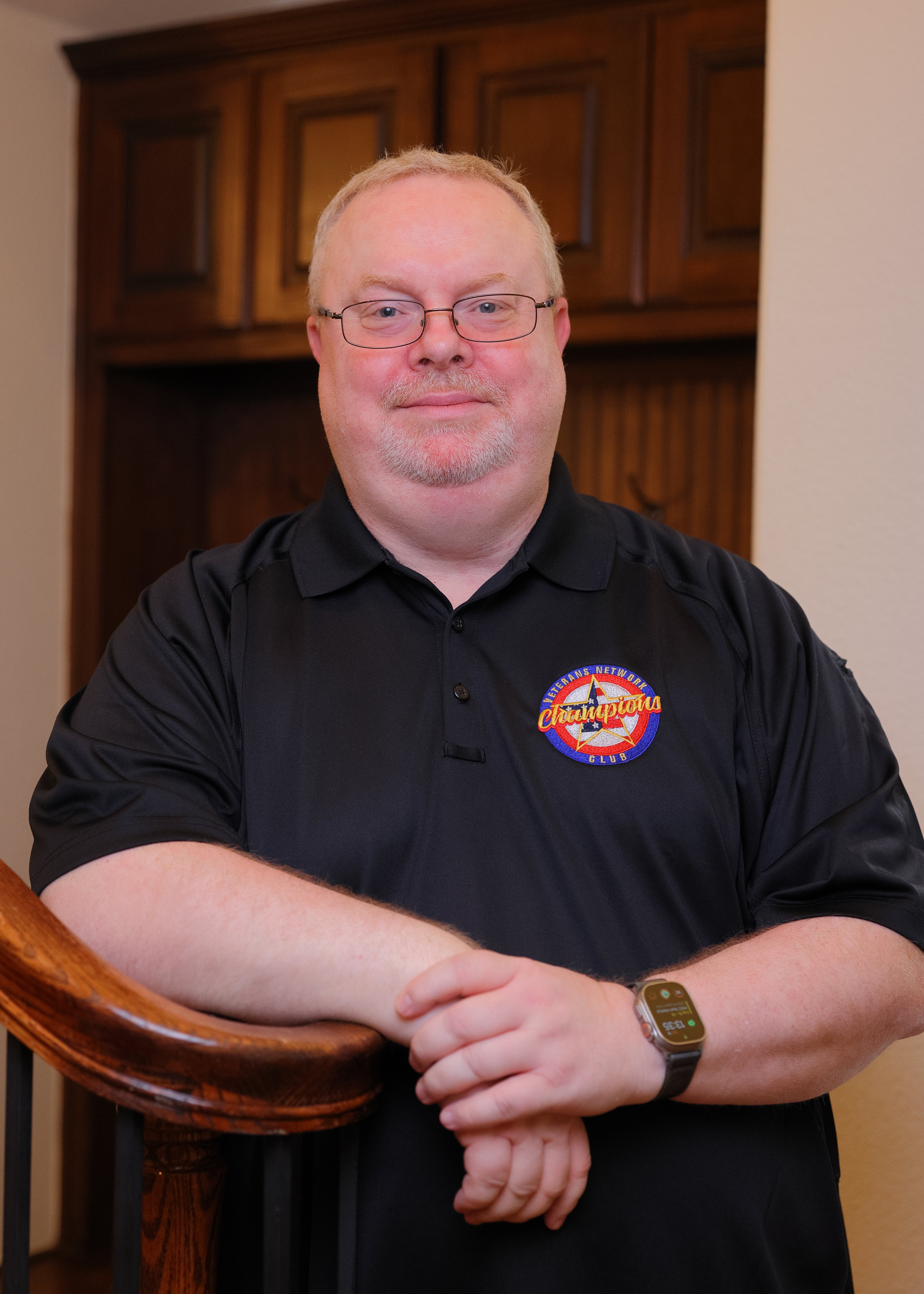 Senior Benefits Advisor Brian with team shirt