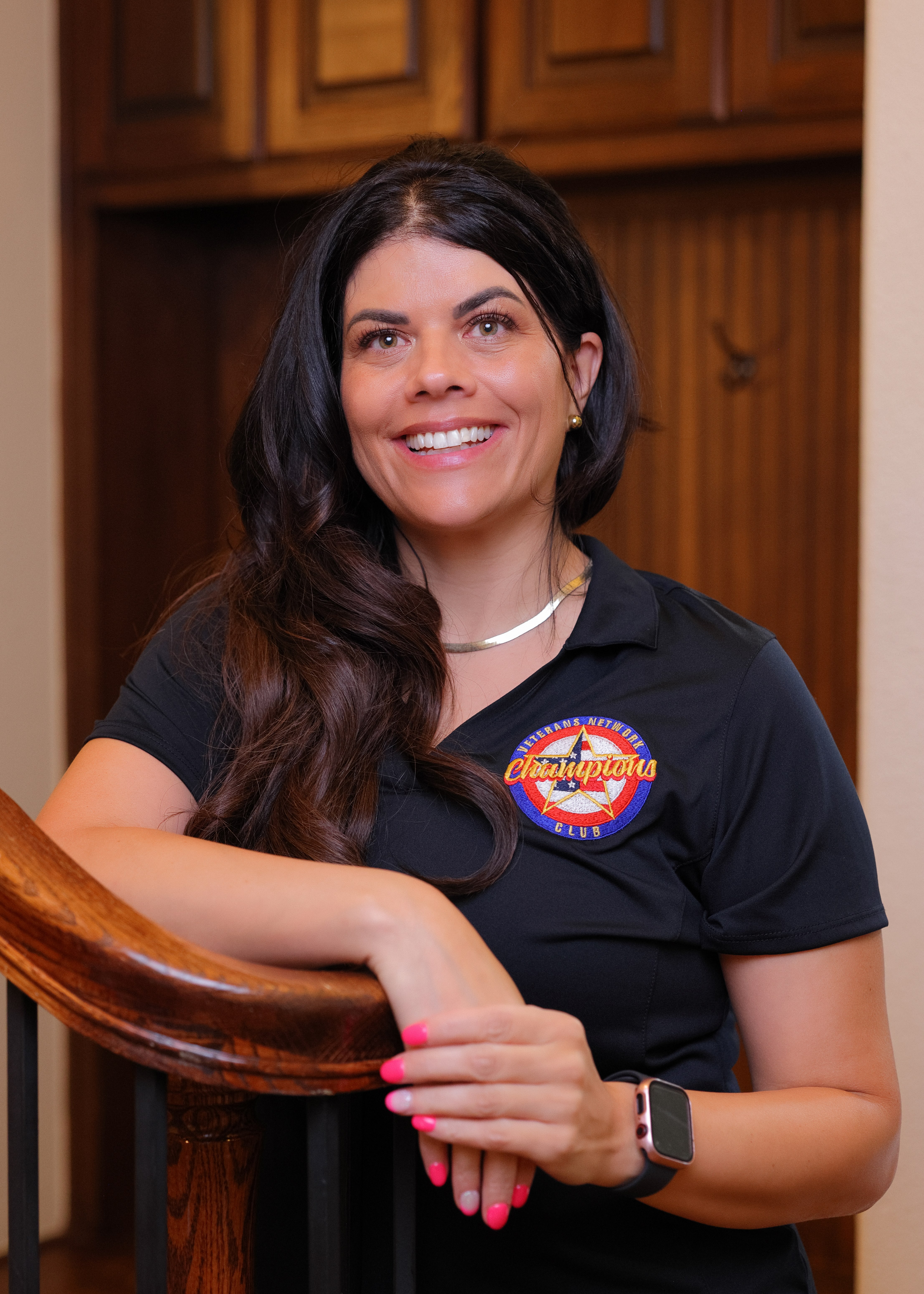 Senior Benefits Advisor Amy with team shirt and arms crossed