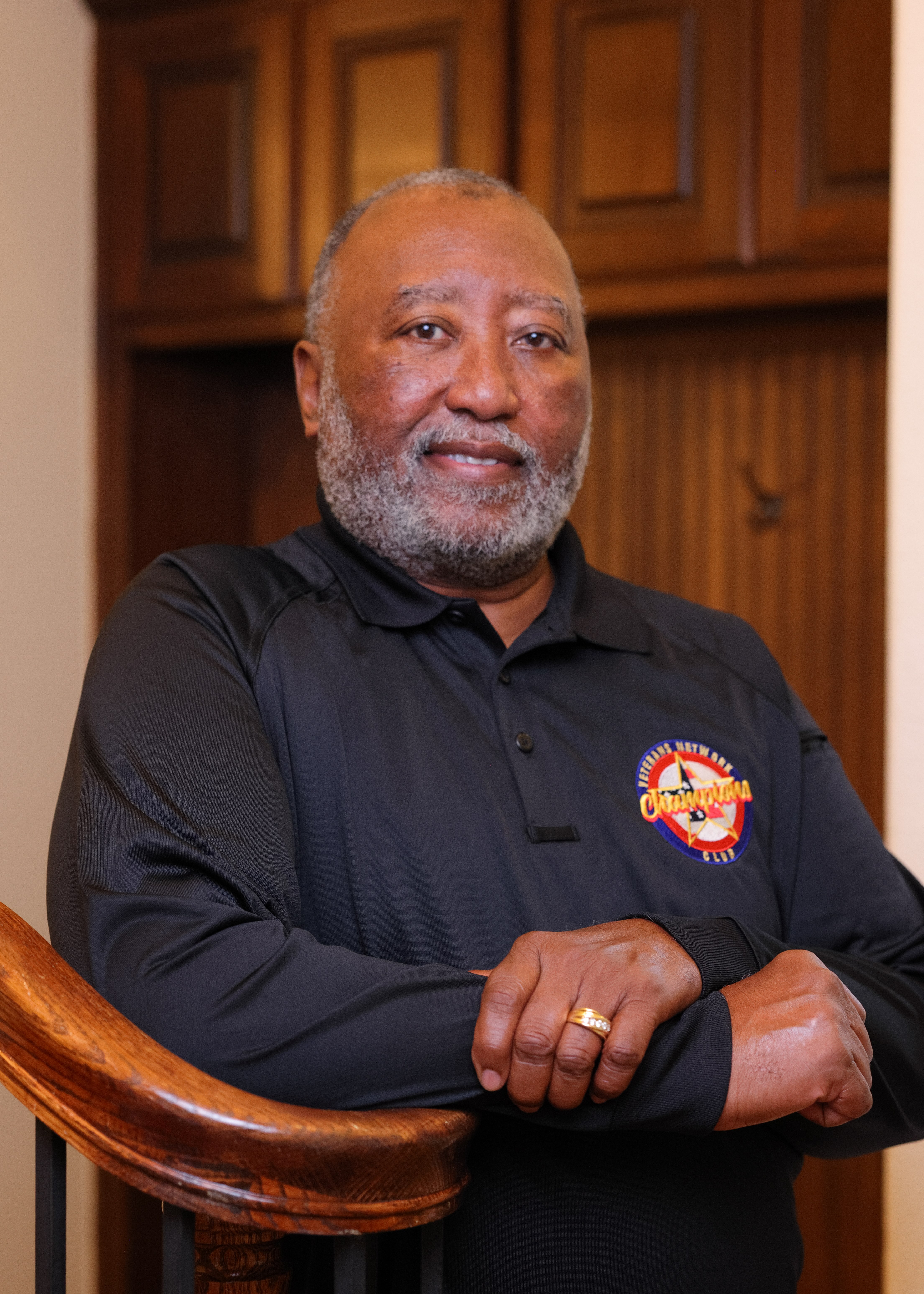 Benefits Advisor Vernon with team shirt and arms crossed