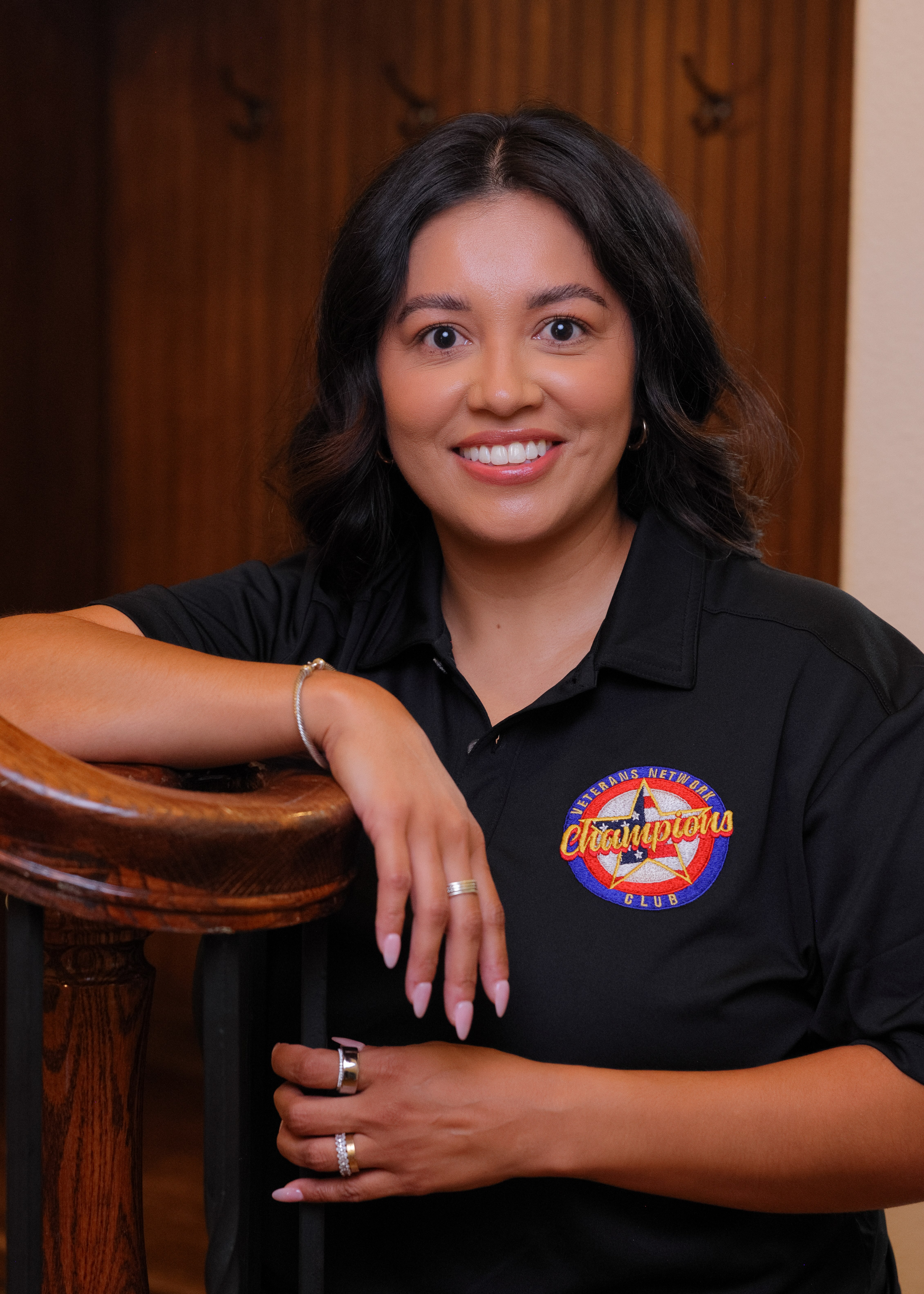 Senior Benefits Advisor Nayeli with team shirt and arms crossed