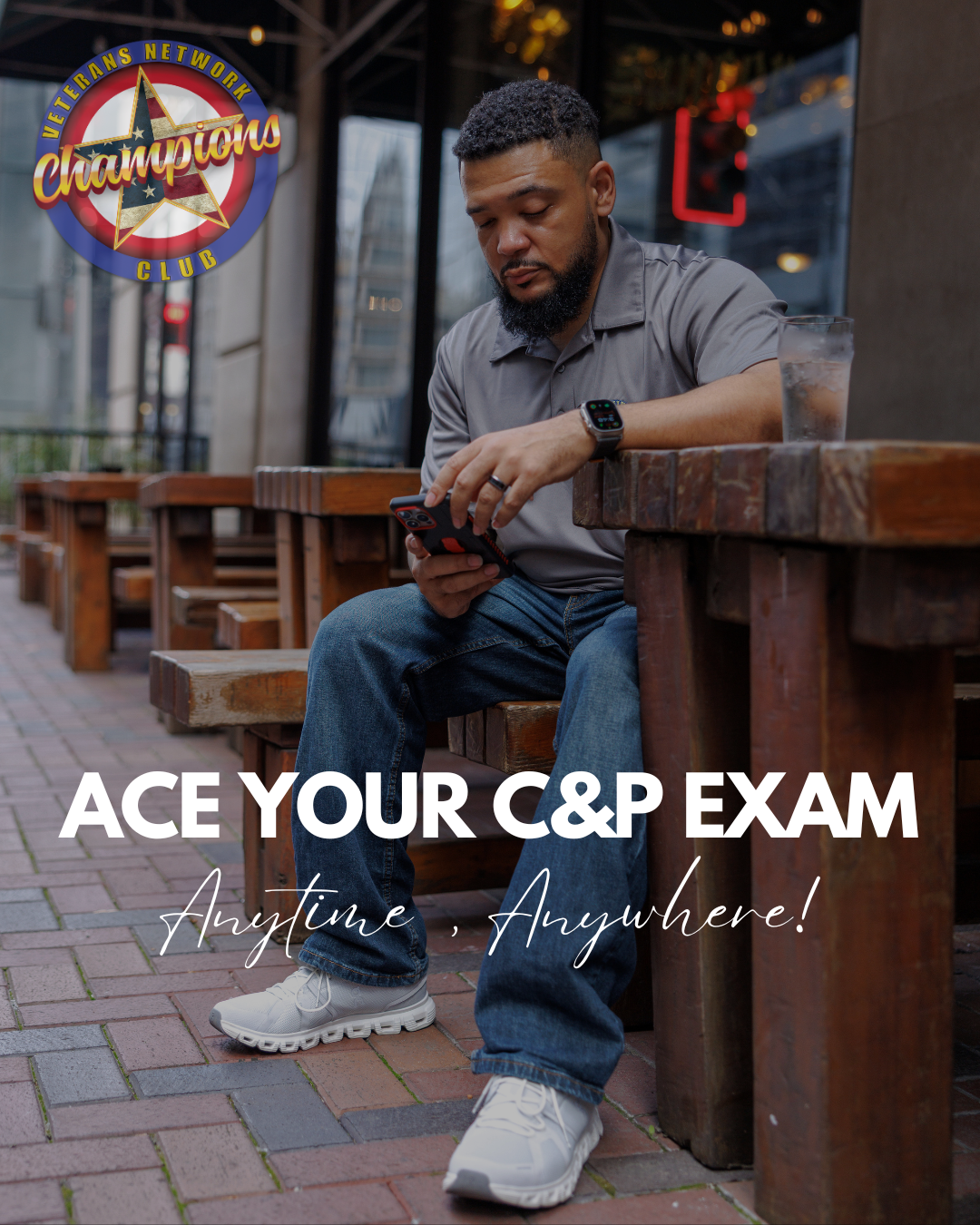 VNCC founder DP seated in front of restaurant looking down at iphone with overlay text "ace your C&P exam anytime, anywhere"